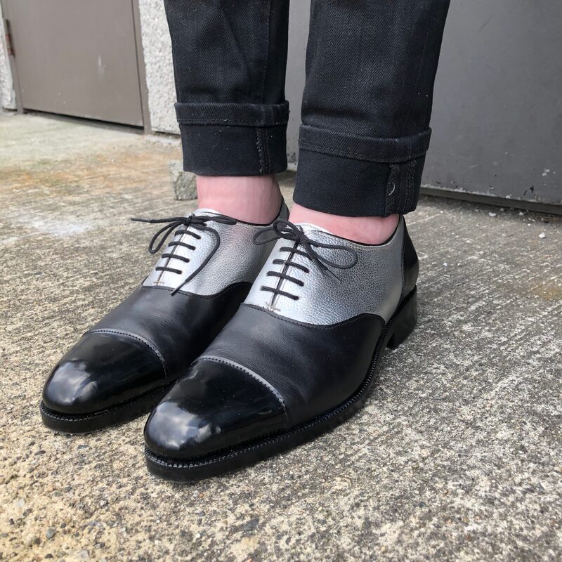 Handmade black and silver oxford shoes worn with dark jeans